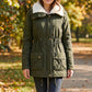 Veste matelassée à capuche mi-longue pour femme